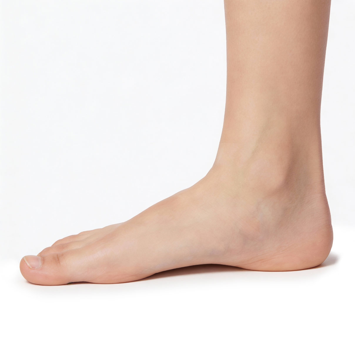 A close-up side view of a bare human foot and lower leg on a white background.