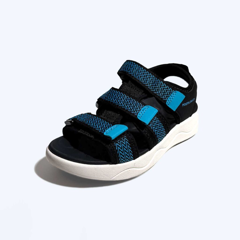 A single open-toe sandal with three blue and black adjustable straps and a white, contoured sole is shown against a plain background.